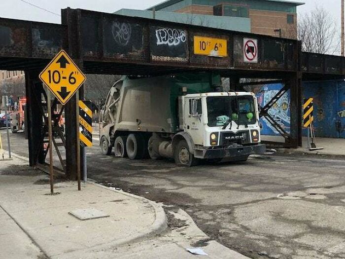 Garbage Truck In Ann Arbor, Michigan Stuck Under Railroad Bridge