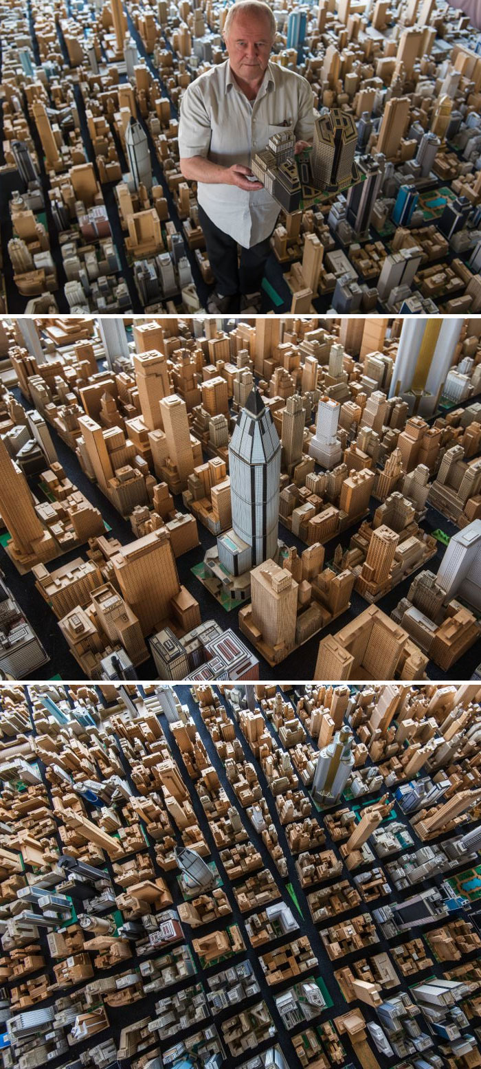 Man holding a lego piece in a lego city 