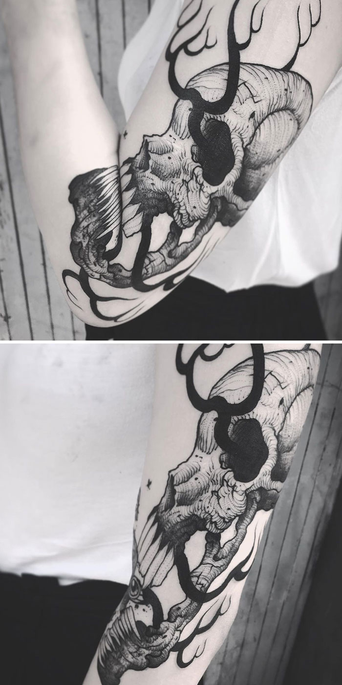 Creative tattoo of a skull and antlers on arm, transforming with arm movement.