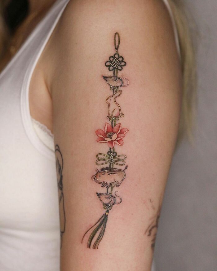 Beautiful body art featuring a floral and animal design tattooed on an arm.