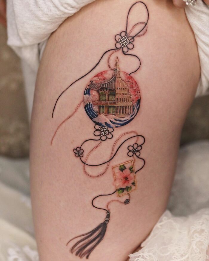 Beautiful body art featuring intricate design with floral elements and architectural details by tattoo artist Sion Kwak.