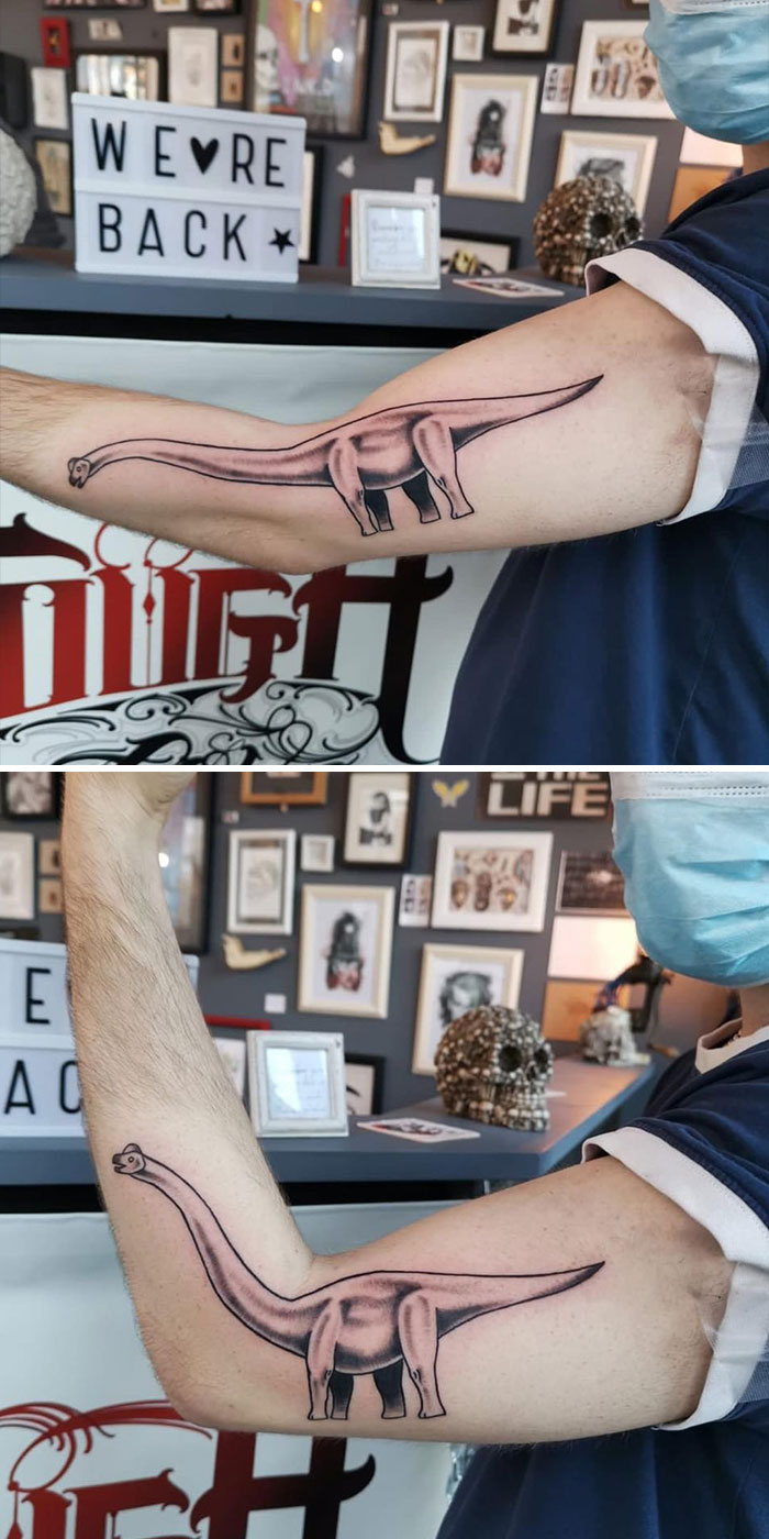 Creative dinosaur tattoo on arm flexes, transforming with body movement.