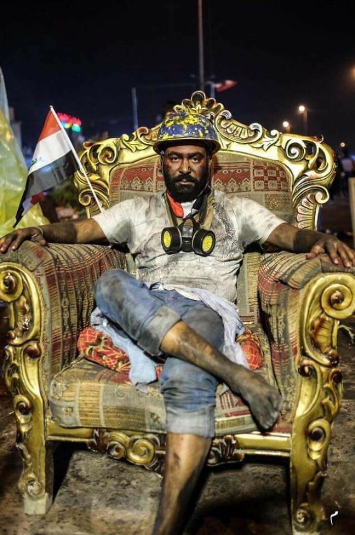 Iraqi Protestors Sit On Government Chairs After They Take Over Government Buildings