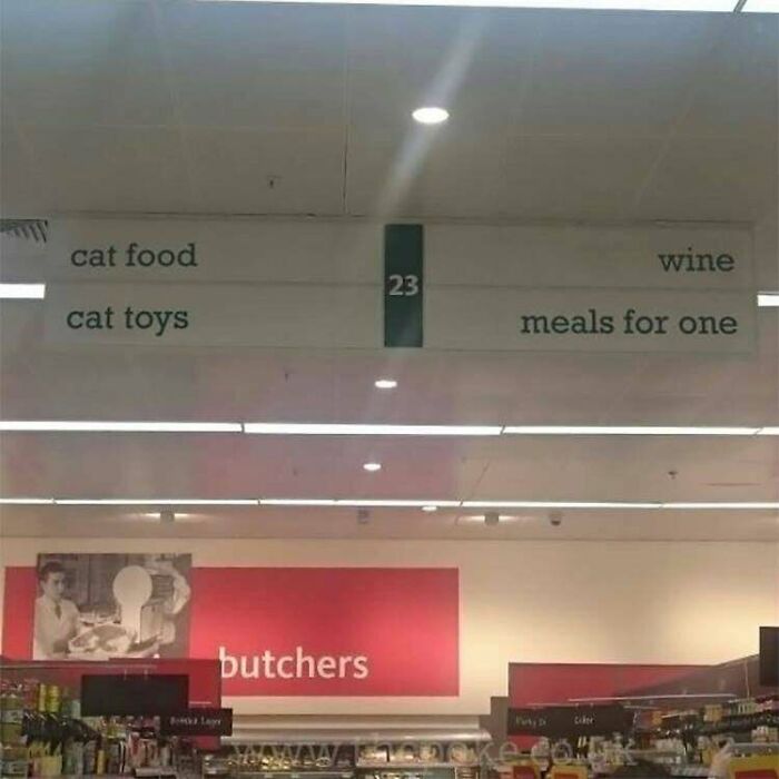 Supermarket aisle sign with cat items, wine, and meals for one, humorous starter pack meme.
