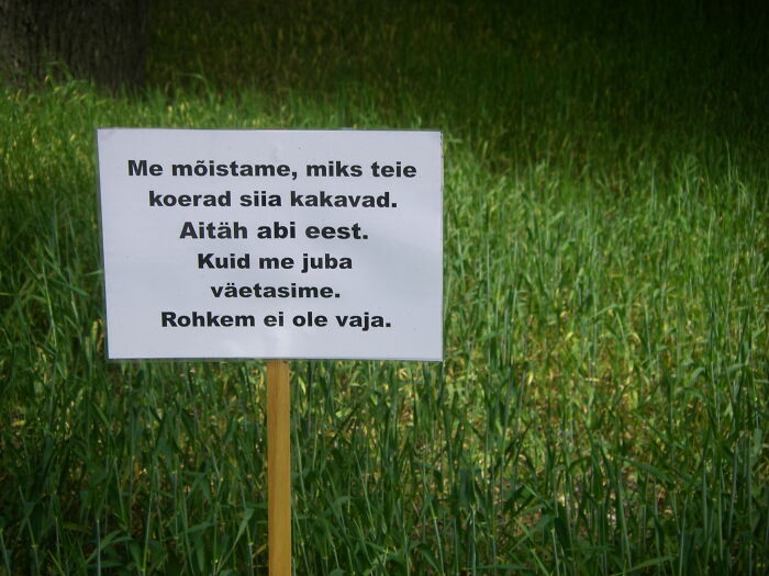 Text On The Sign: We Understand Why Your Dogs Are Pooping Here. Thanks For Your Help. But We Already Fertilized. There’s No Need For More.