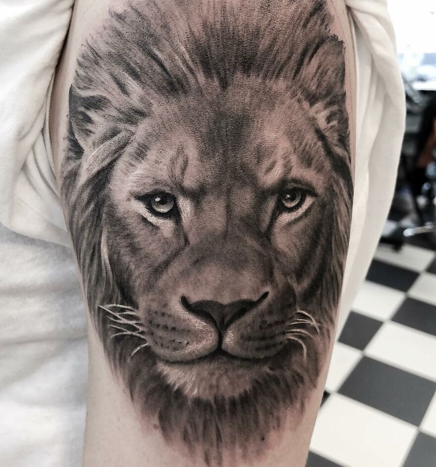 Lion tattoo in black and gray realism on an arm, showcasing the skill of a Swedish tattoo artist.