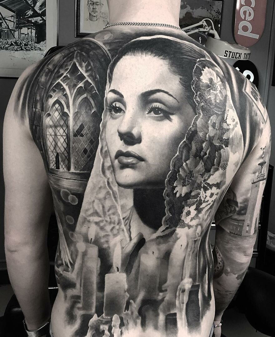 Back tattoo of a woman's portrait in black and gray realism by Swedish artist, showing intricate detail.