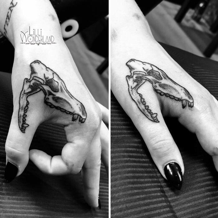 Creative tattoo of a skull on a hand, transforming as the fingers move, showcasing artistic motion.