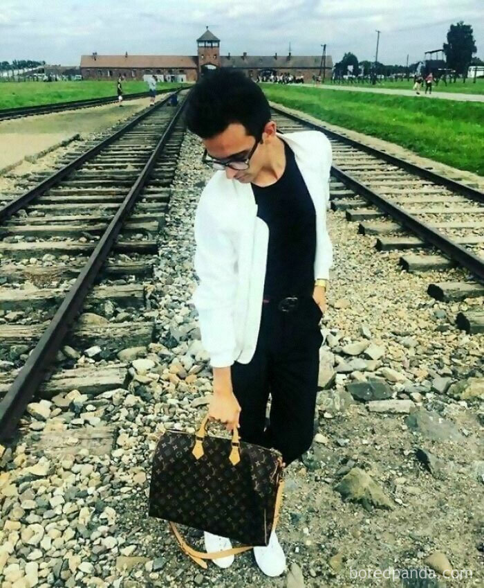 Dude Is Flexing His Louis Vuitton Bag On Auschwitz Train Tracks