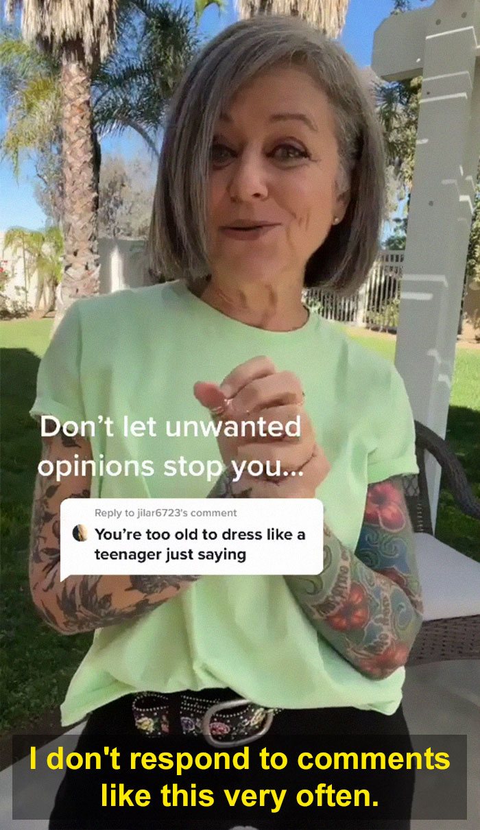 Woman in her 50s wearing a colorful tattooed outfit, confidently responding to being told she is too old to dress like a teenager. Woman in her 50s wearing a colorful tattooed outfit, confidently responding to being told she is too old to dress like a teenager.