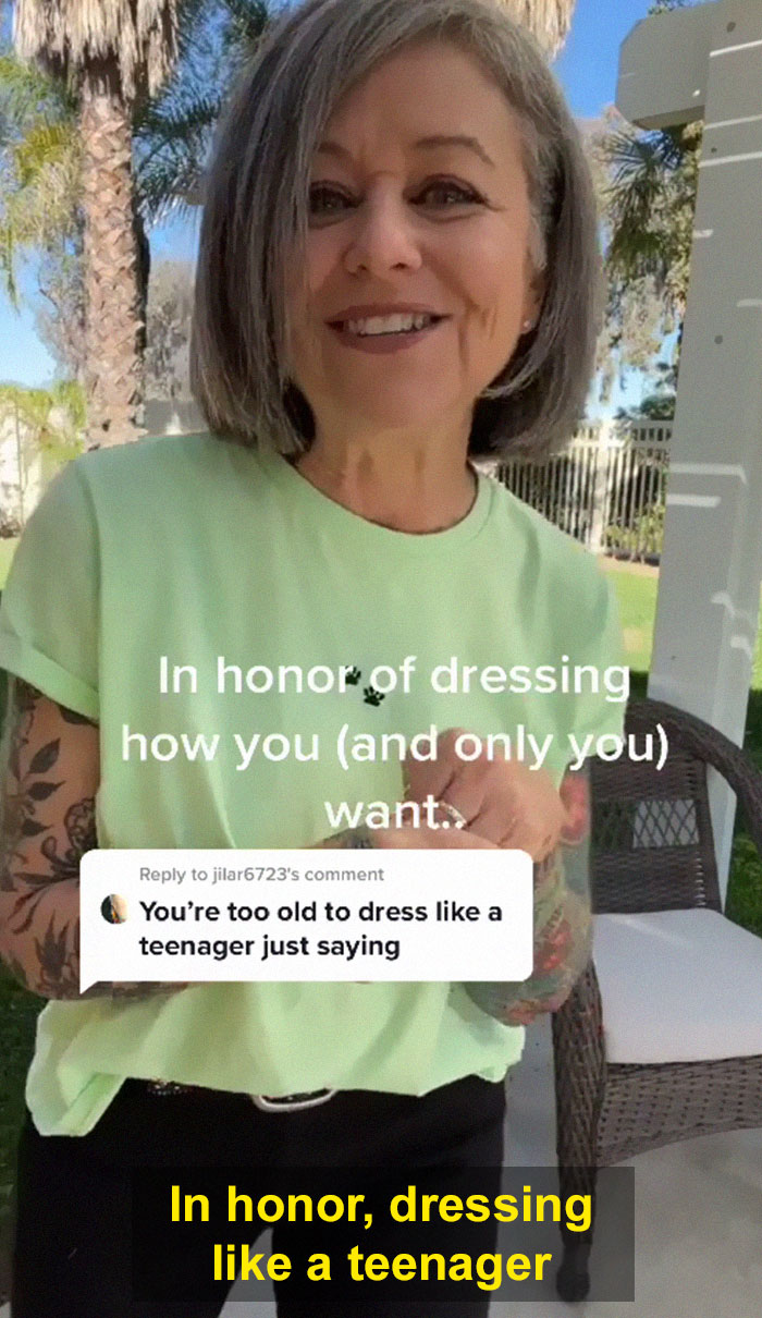 Woman in her 50s confidently dressed like a teenager, responding to criticism about her outfit choice outdoors. Woman in her 50s confidently dressed like a teenager, responding to criticism about her outfit choice outdoors.
