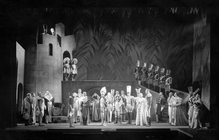 Black and white theatrical stage scene with actors in historical costumes, illustrating interesting facts people didn’t learn at school.