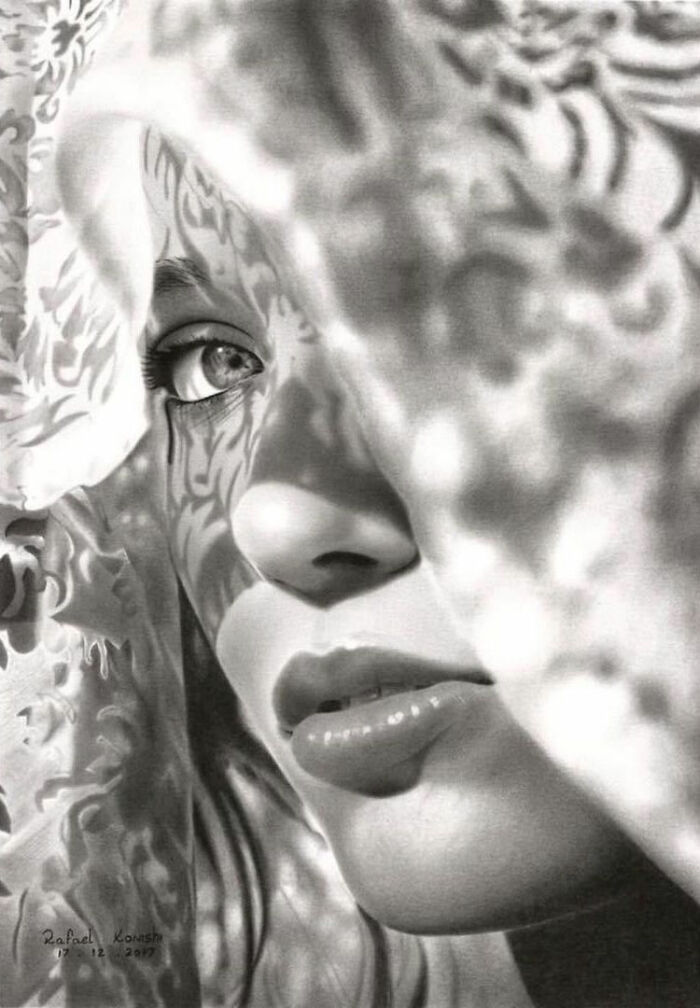 Realistic drawing by Rafael Konishi depicting a woman's face with intricate shadow patterns on her skin.