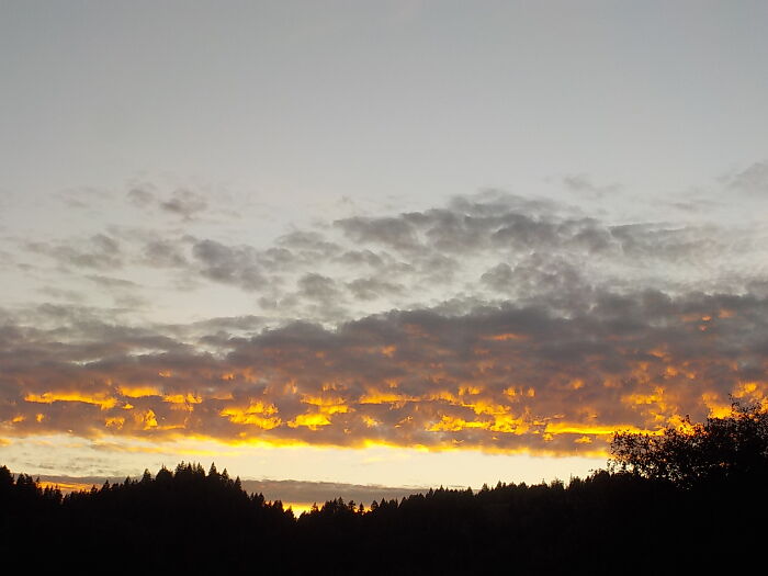 A Sunset Photo That Looks Like The Clouds Are On Fire