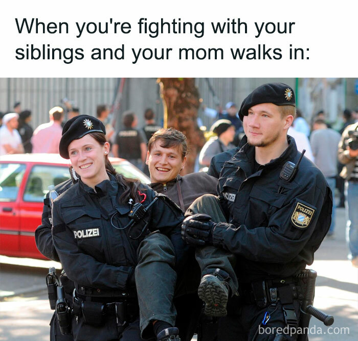 Police officers humorously carrying a smiling person, illustrating a relatable meme moment.