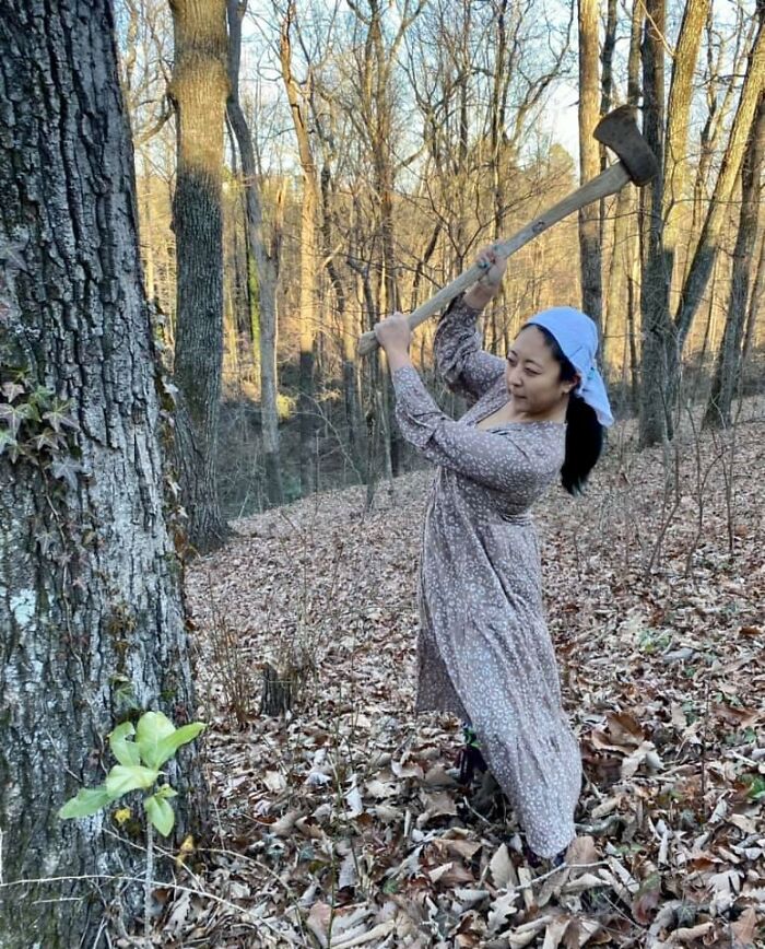Local Pioneer Woman Wields Her Axe — Her First Time Chopping Wood For The Fire. Because Of The Pandemic, She Was Forced To Sell Her Home, Move Out Into Nature, And Resort To More Primitive Ways Of Living