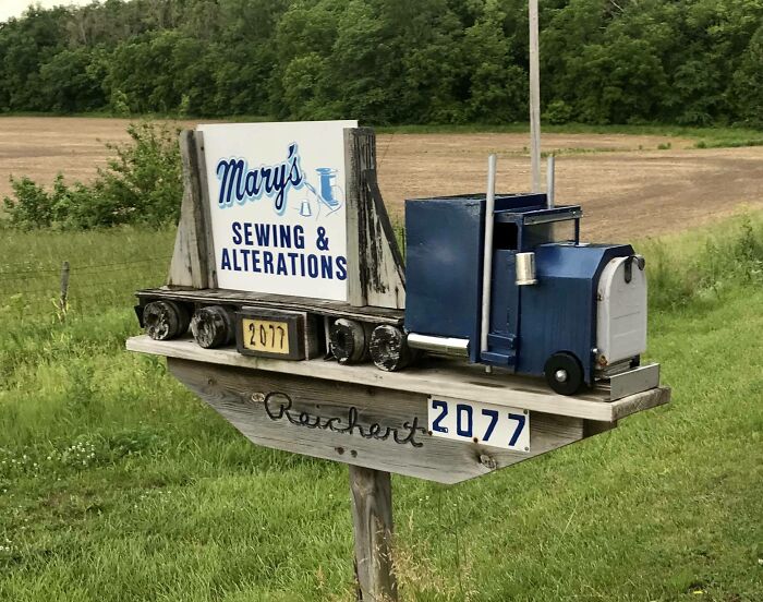 Creative mailbox shaped like a truck with sewing and alterations sign, showcasing one of the coolest mailboxes in the wild.