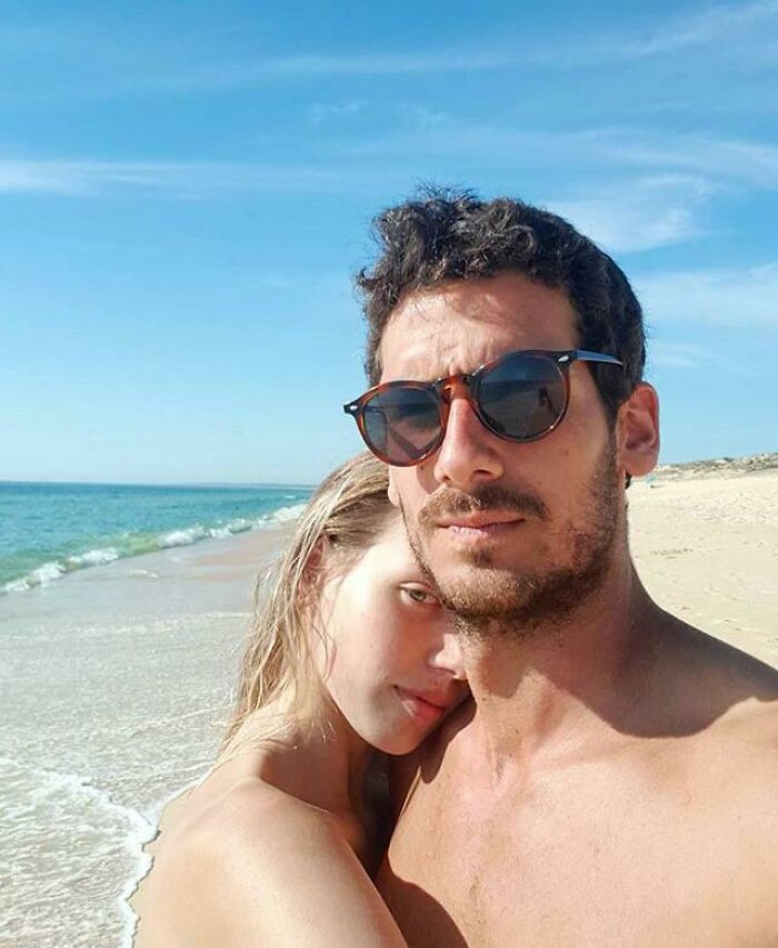 Her Shoulder Blends With The Sand