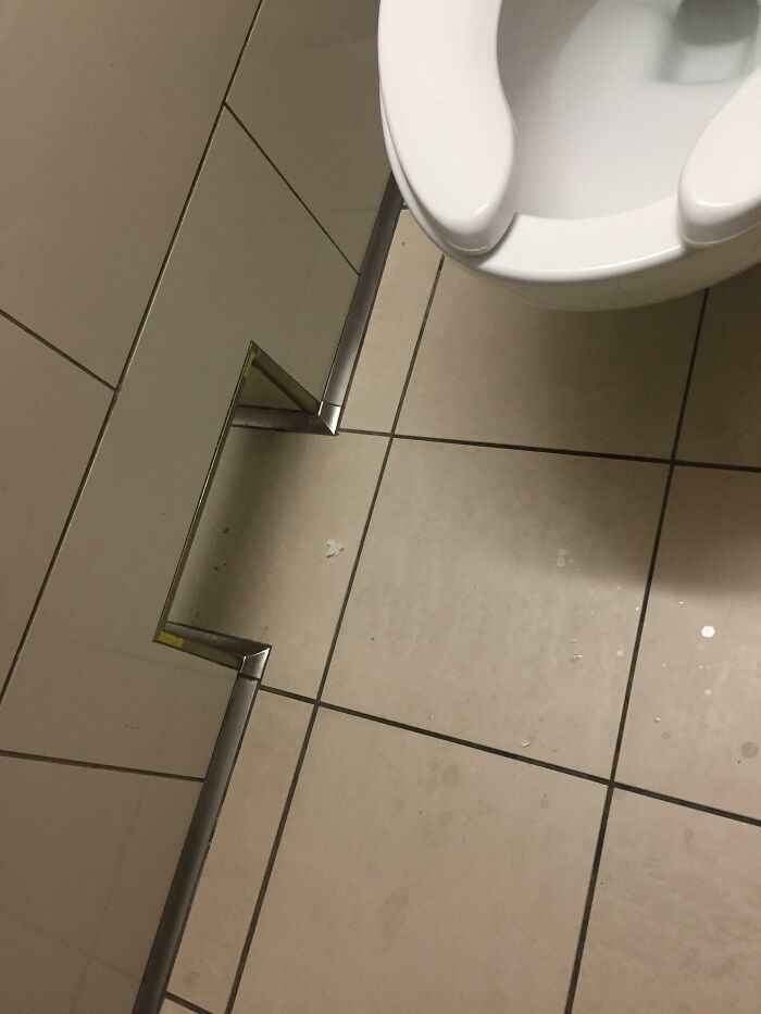 This Public Restroom Has A Passage In Between Stalls To Pass Toilet Paper In Between