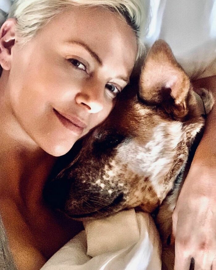Celebrity cuddling with her dog, showing immense love for dogs in a close, affectionate moment.