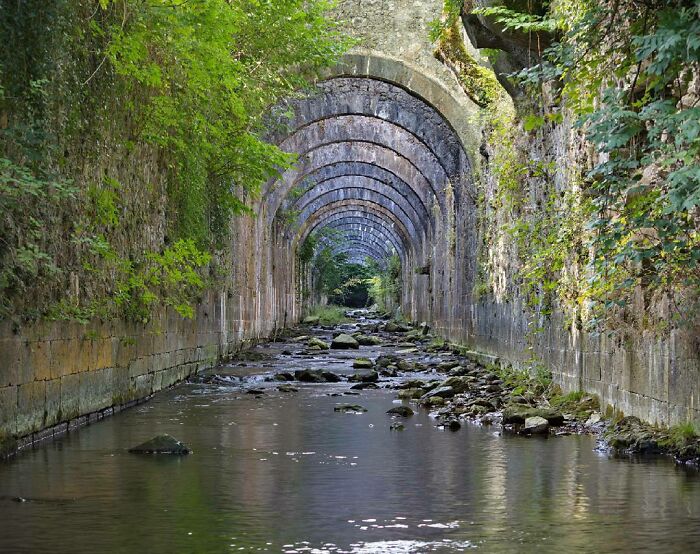 Waterway Underneath An Old Spanish Arms Factory Being Overtaken By Nature: Like A Scene From LoTR
