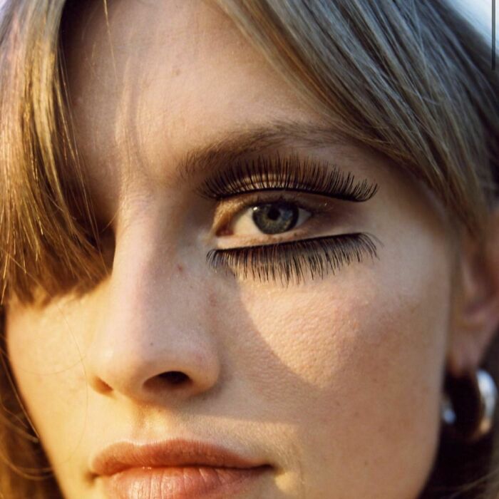 Close-up of a model with dramatic false eyelashes, illustrating Zara shoppers' critique of unusual modeling poses.