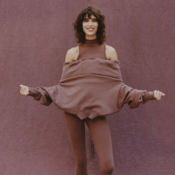 Zara model in unique pose wearing brown outfit, highlighting shoppers' online shopping experience challenges.