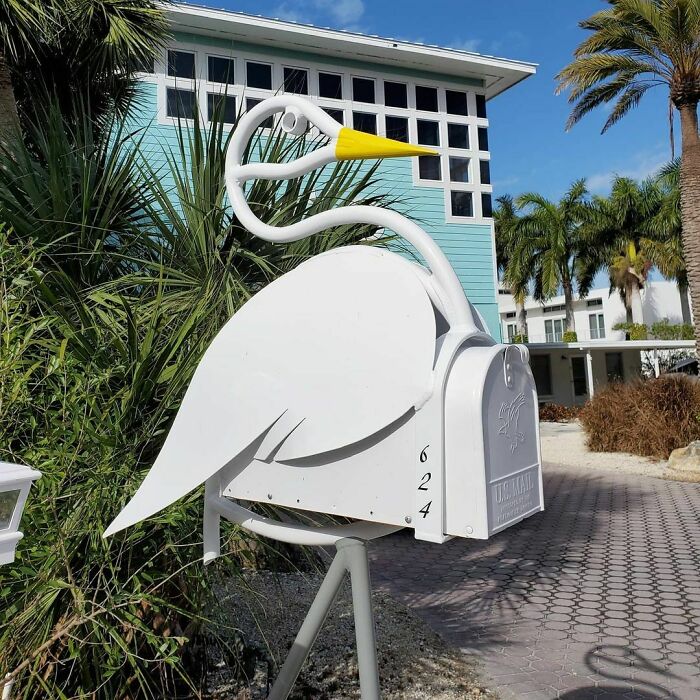 Creative white bird-shaped mailbox with unique design in a tropical setting, showcasing cool mailboxes spotted in the wild.