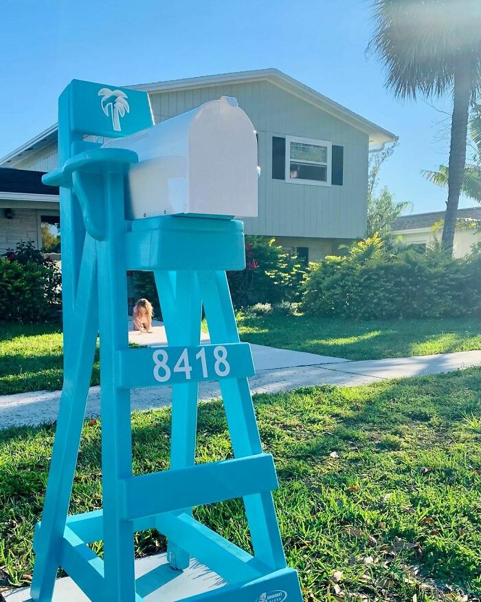 Creative and cool mailbox designed to look like a turquoise lifeguard chair with a white mailbox on top.