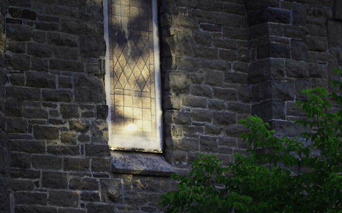 Sunset Through Two Trees Reflected In A Church Window