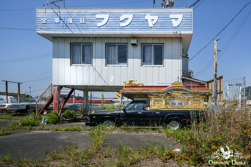 A Japanese Funeral Car, Called A Reikyūsha, Lays Forgotten On An Old Dealership Forecourt