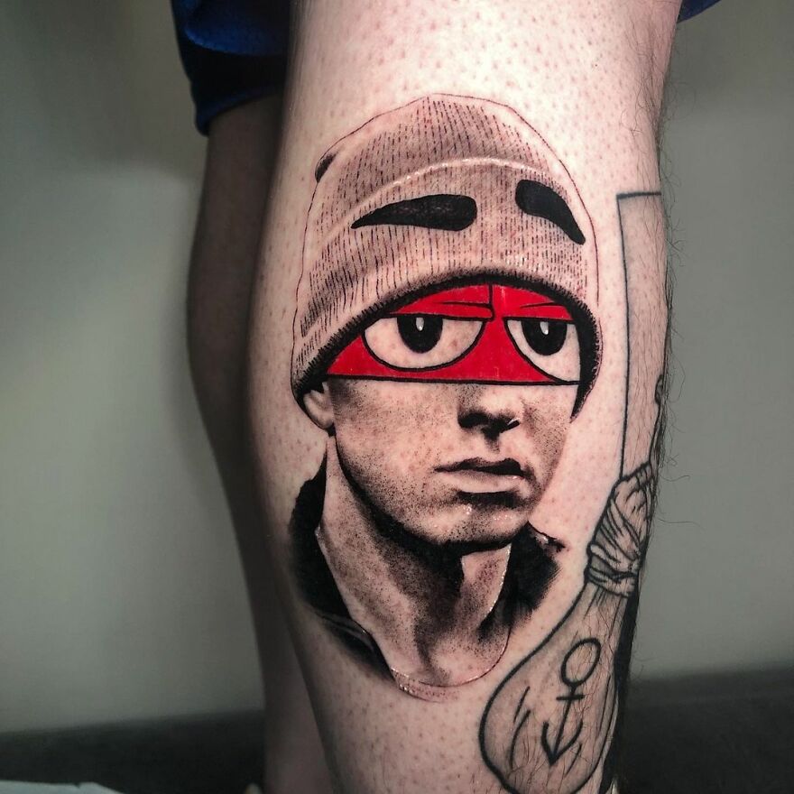 Tattoo on leg combining two different styles by Mat Rule, featuring a face with comic character eyes.