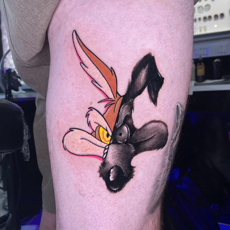 Tattoo on leg featuring two different artistic styles by Mat Rule, showcasing a colorful cartoon character.