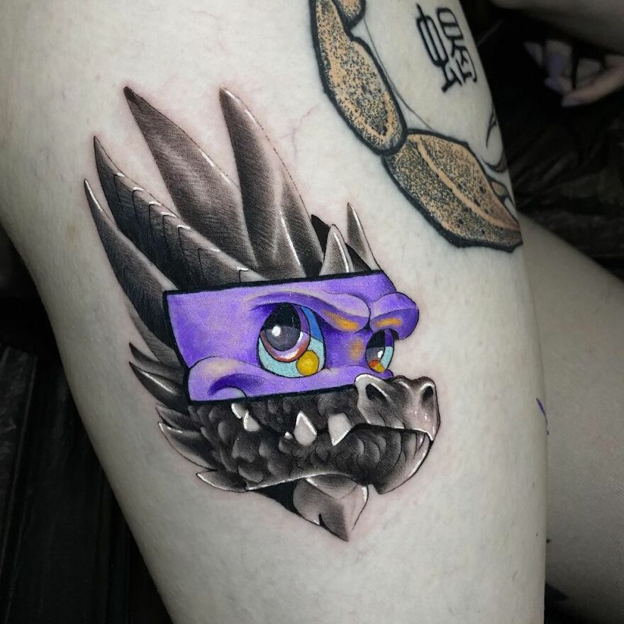 Tattoo combining a dragon and cartoon style by Mat Rule, featuring bold colors and intricate details.