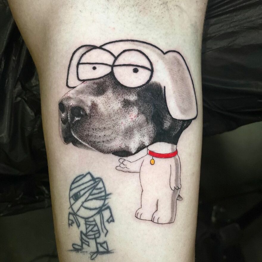 Mixed-style tattoo of a cartoon dog and a mummy on skin, showcasing creative art by Mat Rule.