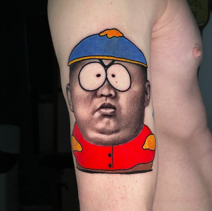 Tattoo blending two art styles by Mat Rule, featuring a cartoon character with a realistic human face on an upper arm.