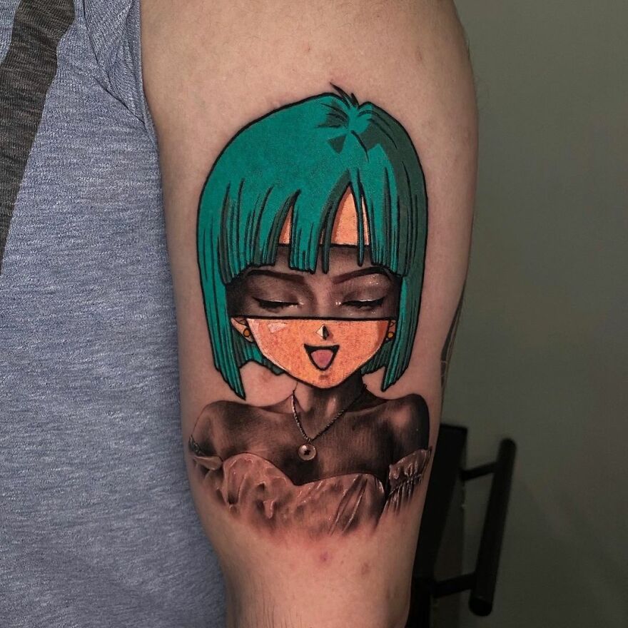 Tattoo featuring a character with green hair and closed eyes, combining two different styles on an arm.