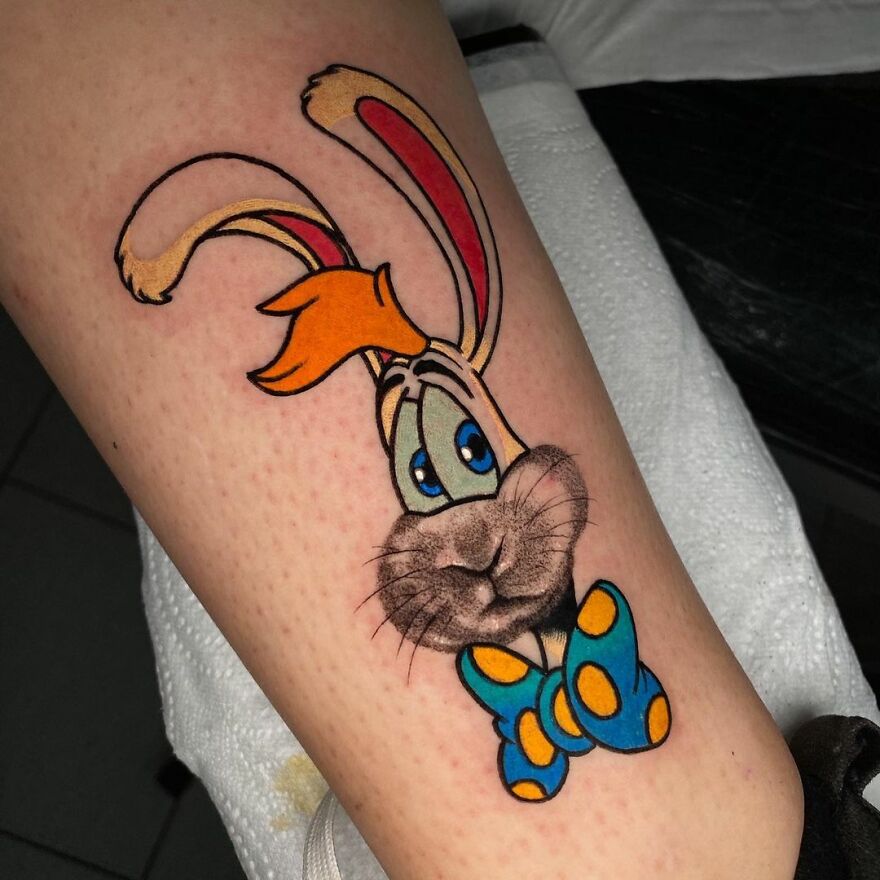 Tattoo of a cartoon rabbit, showcasing two different styles by Mat Rule.