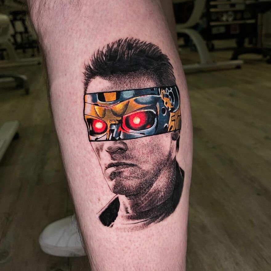 Tattoo combining realistic and graphic styles by Mat Rule, featuring a robotic figure with red glowing eyes.