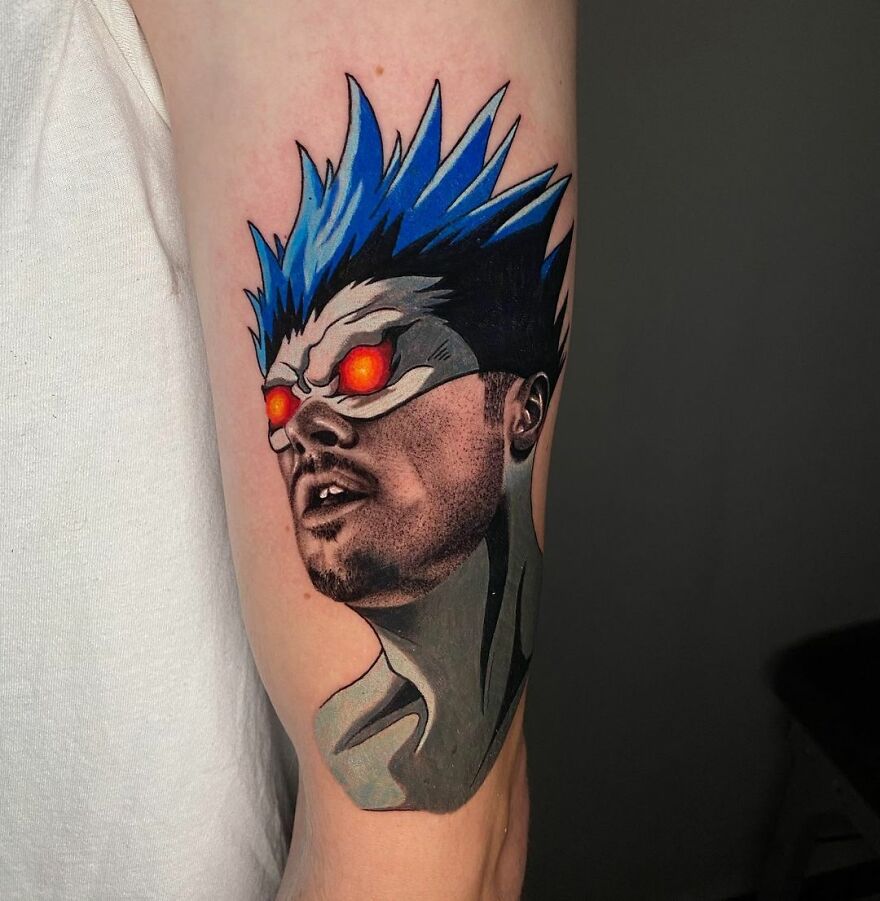 Tattoo by Mat Rule showcasing two different styles, featuring a character with blue hair and glowing red eyes on an arm.