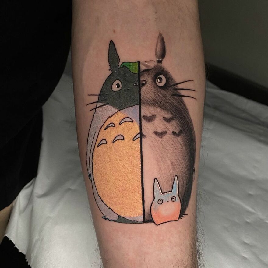 Unique tattoo on arm combining two artistic styles by Mat Rule, featuring split Totoro design.
