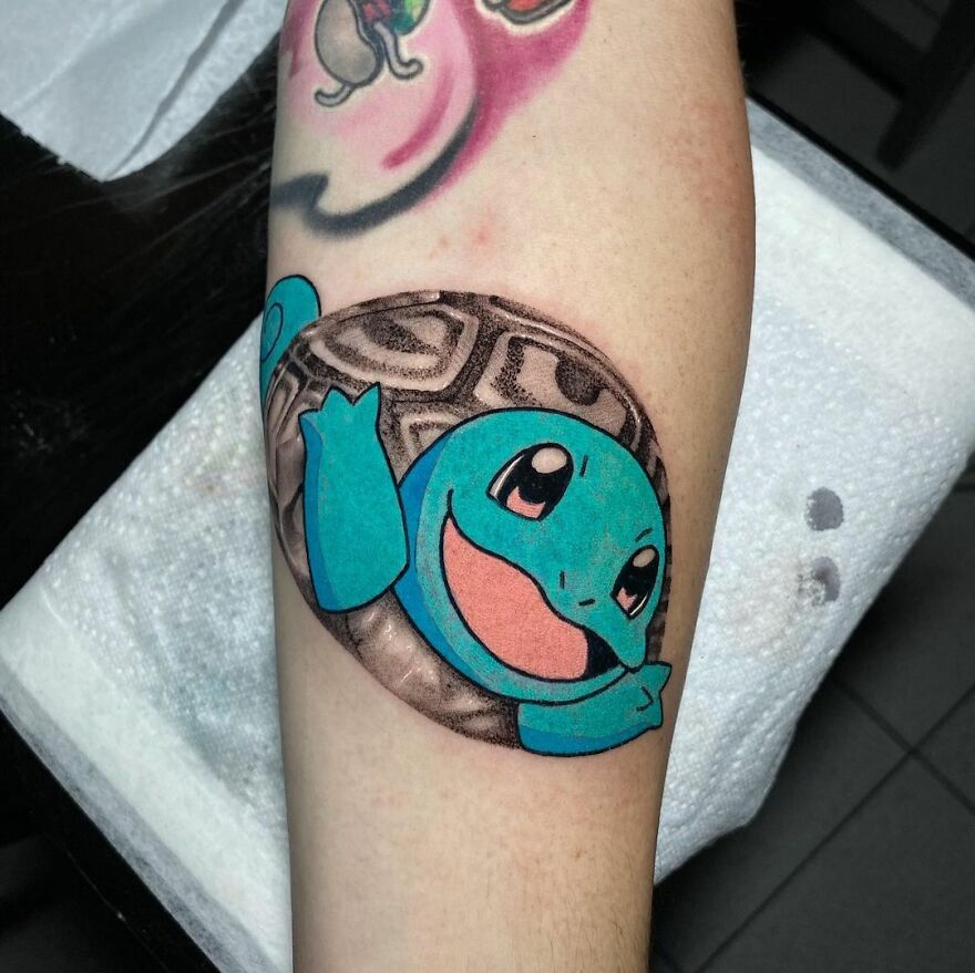 Tattoo of a cartoon turtle on an arm, combining styles for a unique artistic effect.
