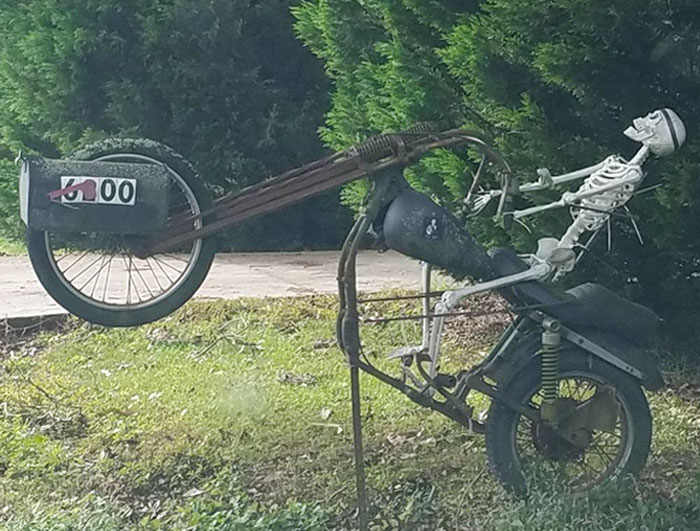 Creative mailbox designed as a motorcycle with a skeleton rider, showcasing one of the coolest mailbox ideas spotted in the wild.