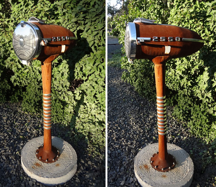 Unique creative mailbox designed from vintage car parts, standing outdoors amidst greenery, showcasing cool mailbox ideas.