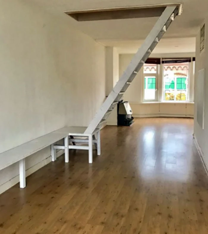 This Apartment Has A Bench Attached To The Stairs