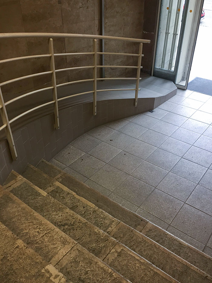A Handicap Ramp With A Step At The Bottom
