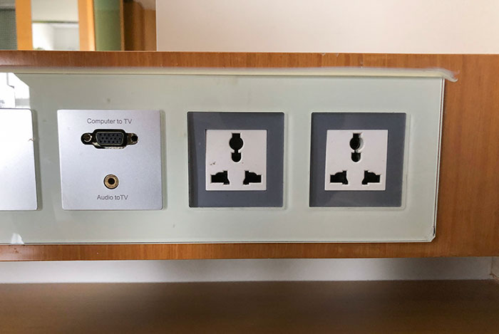These Sockets In A Chinese Hotel Room Fit Us, Chinese, European, And UK Plugs