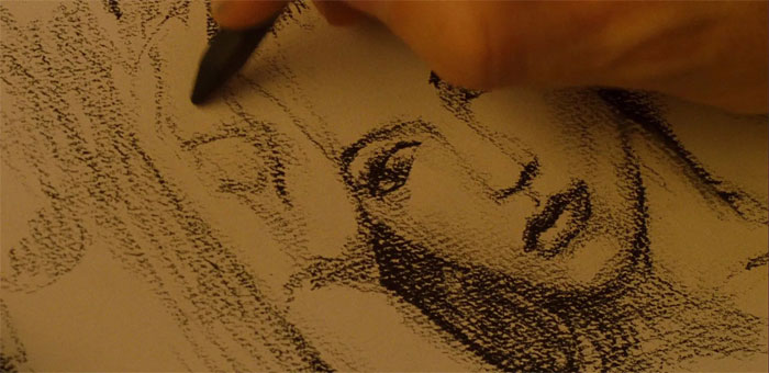 a person drawing the portrait of a woman