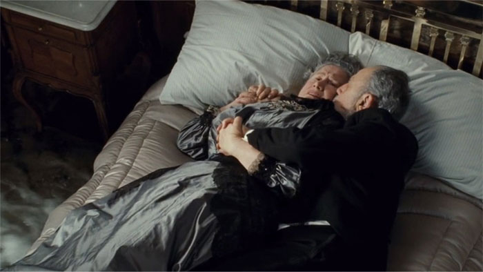 the elderly couple lying in bed