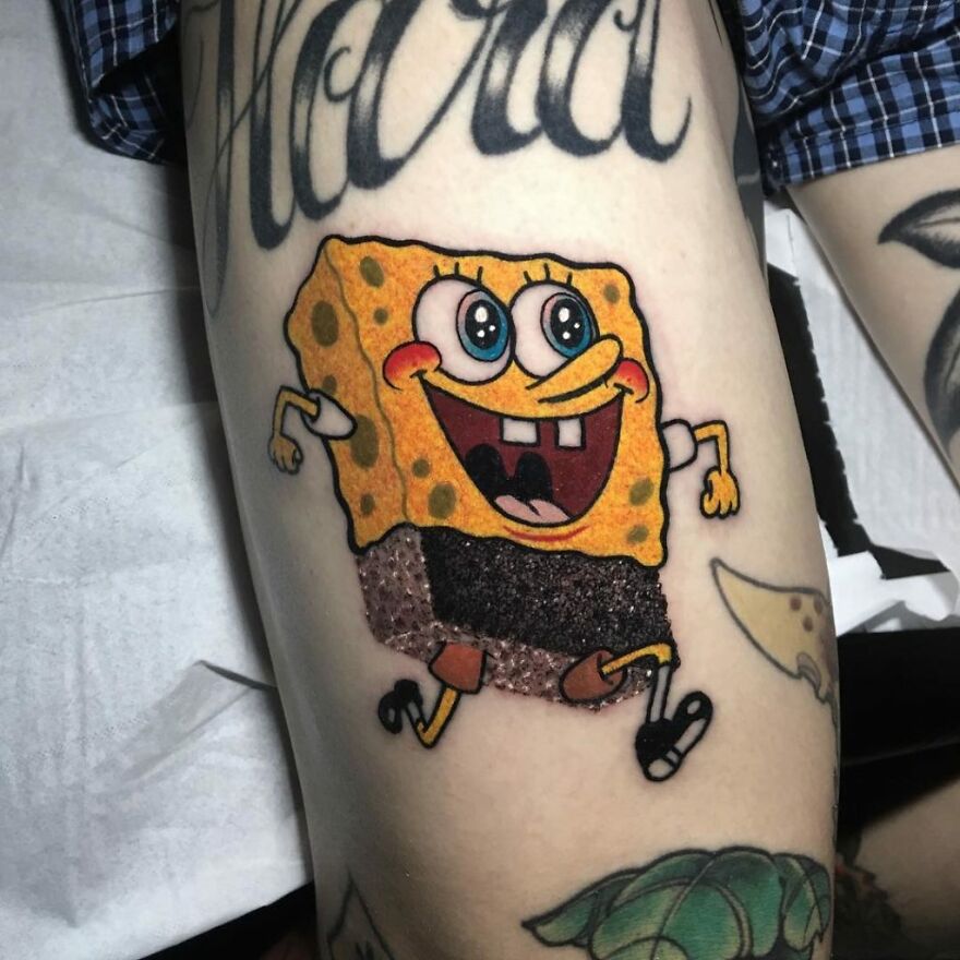 Unique tattoo combining styles featuring a cartoon character on an arm, showcasing ink art creativity.